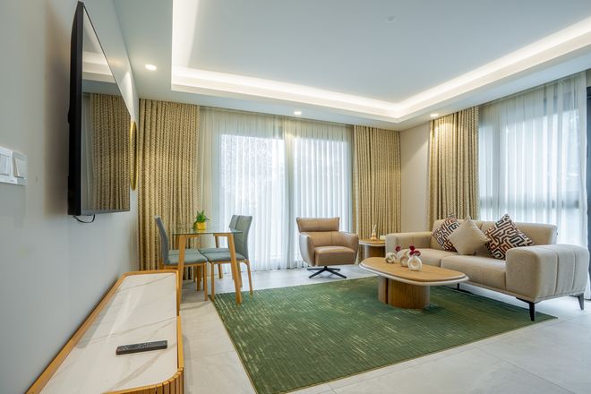 Living room of a furnished three-bedroom apartment at Grand Mirage