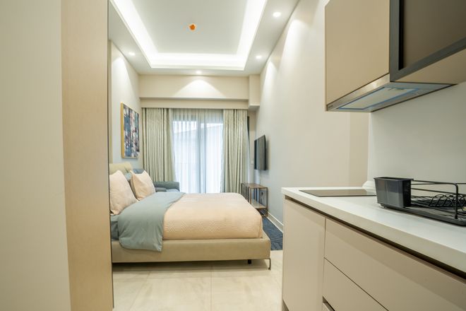 Sleeping and kitchen area of a studio apartment at Grand Mirage