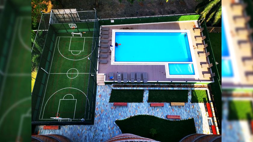 Rooftop pool and sports court at Mirage Residence from the air